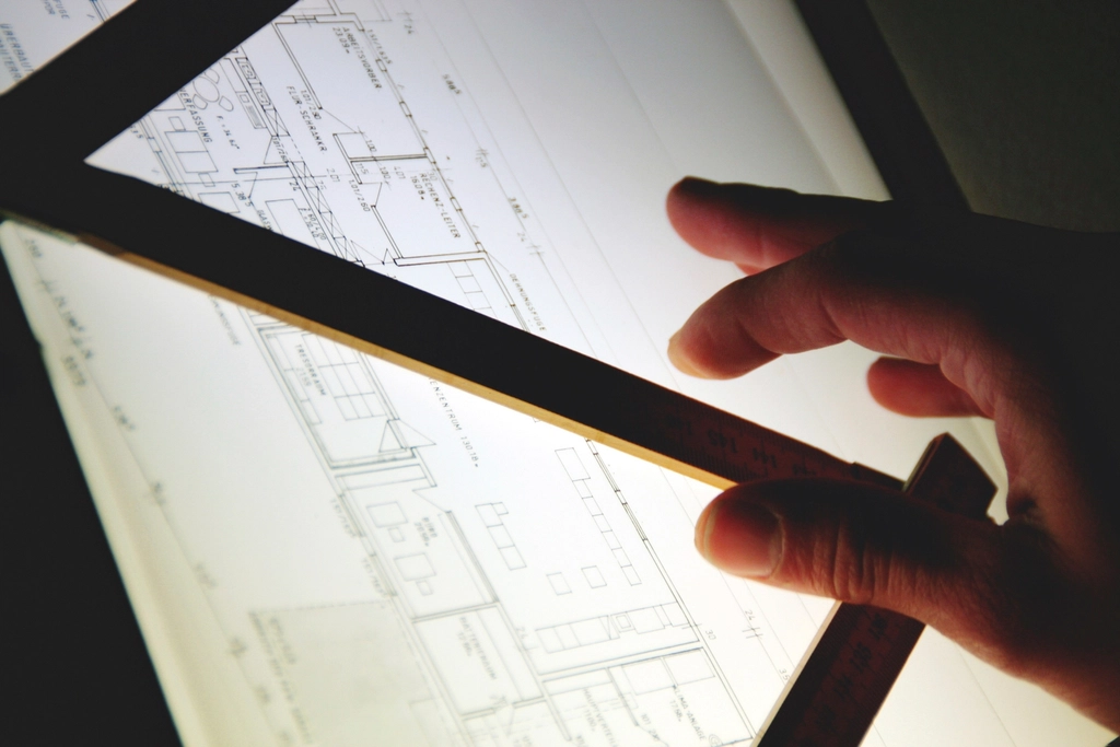 Architect measuring construction drawings